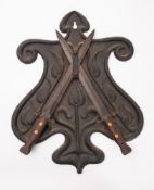 Two British Lee Metford 1888 pattern bayonets mounted on a cast iron shield.