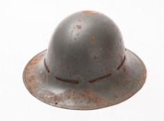 A WWII Zuckerman steel helmet. With stamps to the rim and leather sweatband, size 6.75.