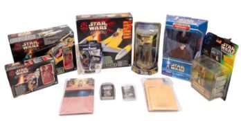 A Hasbro Star Wars Naboo fighter together with two other Star Wars vehicles.