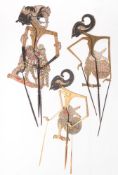 A group of three Javanese Wayang Kulit shadow puppets in painted parchment with horn sticks,