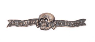 A WWII German Waffen SS skull breast badge.