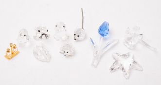 A mixed collection of twenty-two Swarovski glass figures, including Starfish,
