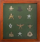 A collection of Ghurka cap badges. Mounted, framed and glazed, 33cm high, 31cm wide.
