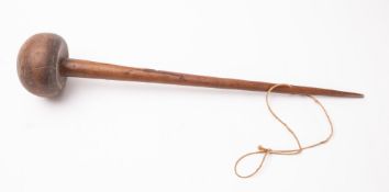A 20th Century Oceanic throwing club. Having a tapering shaft to rounded head, 74cm long.