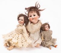 Three small Continental bisque head doll