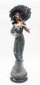 A painted resin model of a maiden with a