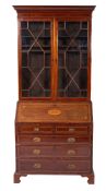 An Edwardian mahogany and inlaid bureau bookcase, bordered with sycamore, boxwood and ebony lines,