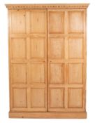 A pine wardrobe, with a moulded dentil cornice.