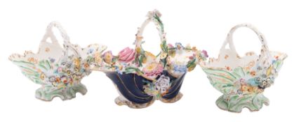 A Coalport flower-encrusted basket and a pair of similar baskets,
