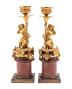 A pair of fine Continental ormolu and rouge royale marble figural candle holders,