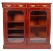 A Victorian mahogany and glazed bookcase, late 19th century; the top with moulded edges,