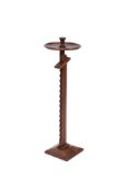 A walnut adjustable ratcheted candle stand, the circular dished top with sconce,
