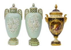 A Coalport fruit-painted vase and cover and a pair of Brown Westhead & Moore reticulated vases