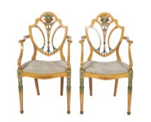 A pair of early 19th century painted and decorated elbow chairs in the Sheraton manner,