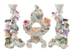 A pair of Coalport rococo candlesticks and a similar watch holder,