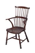 An early 19th century elm and fruitwood comb back Windsor elbow chair,