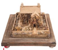 A folk art model of a house and garden, 20th century; made with fabric scraps,