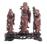 A set of Chinese carved hardwood figures of the three Star Gods and stand,