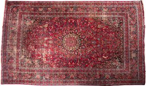 A Tabriz carpet, the wine field with a central flowerhead pole medallion,