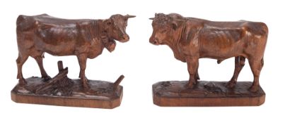 A pair of 'Black Forest' carved linden wood models of cattle, probably Brienz,