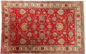 A Tabriz carpet, the rose field with an all over palmette and scrolling floral foliate design,