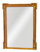 A giltwood overmantel mirror of broken outline,