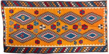 A Qashgai Kelim, the orange field with a design of stepped lozenges and segmented hexagons,