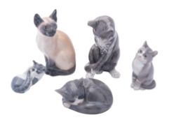 Five Royal Copenhagen porcelain cats comprising Cat Grooming and Sleeping Cat both after originals