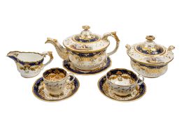 A William Adams porcelain tea service painted with landscape vignettes within blue and gilt borders,