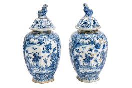 A pair of Dutch Delft jars and matched covers each of hexagonal oviform and painted in blue