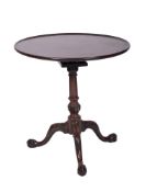 A George III mahogany circular tea table, with a dished snap top,