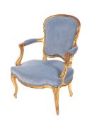 A carved giltwood fauteuil in the Louis XV taste, with an upholstered cartouche shaped back,