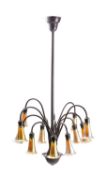A patinated metal and iridescent glass twelve light electrolier in Art Nouveau taste,