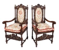 A pair of carved beechwood open armchairs in the Charles II taste,