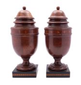 A pair of turned and stained walnut and parquetry side urns,