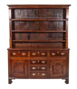 An early 19th century oak and rosewood crossbanded dresser,