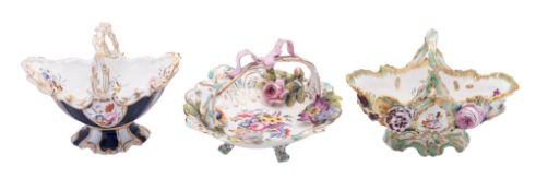 A Coalport shaped oval flower-encrusted basket, one similar and a shaped circular basket,