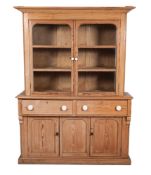 A Victorian pine kitchen dresser, the upper part with a moulded cornice, having fixed shelves,