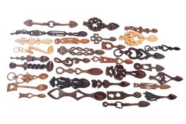 A collection of carved and stained wood love spoons, in traditional style,