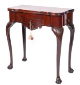 A George III mahogany tea table, of serpentine outline, with a hinged top,