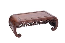 A Chinese Huanghuali wood opium table, with a rectangular top and curved and panelled ends,