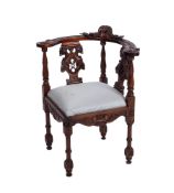 A contemporary hardwood corner elbow chair in Victorian style, with foliate,