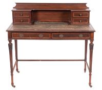An Edwardian mahogany and leather inset writing table,