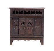 A 19th century carved beechwood table cabinet with open spindle gallery and enclosed by sliding and