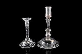 Two glass candlesticks the larger with cylindrical socket set on an inverted baluster stem