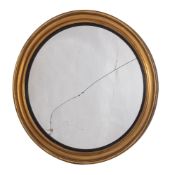 A circular gilt framed mirror of large size in the Regency style,