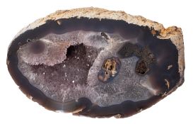 A rock crystal (smoky and clear quartz) half geode; of loosely oval form;