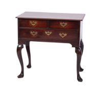A George II mahogany lowboy, the rectangular top with rounded corners and a reeded edge,