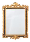 A Brights of Nettlebed contemporary carved giltwood and ebonised wall mirror,