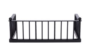 A contemporary blackened steel rectangular fender with square and spirally turned uprights and ball